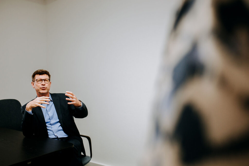 Seated client in business suit during presentation coaching with Ellen Bracquine